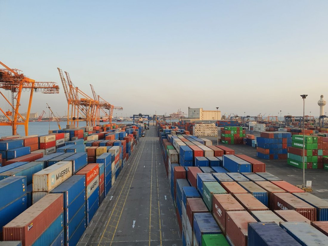 Port cranes over stacked shipping containers