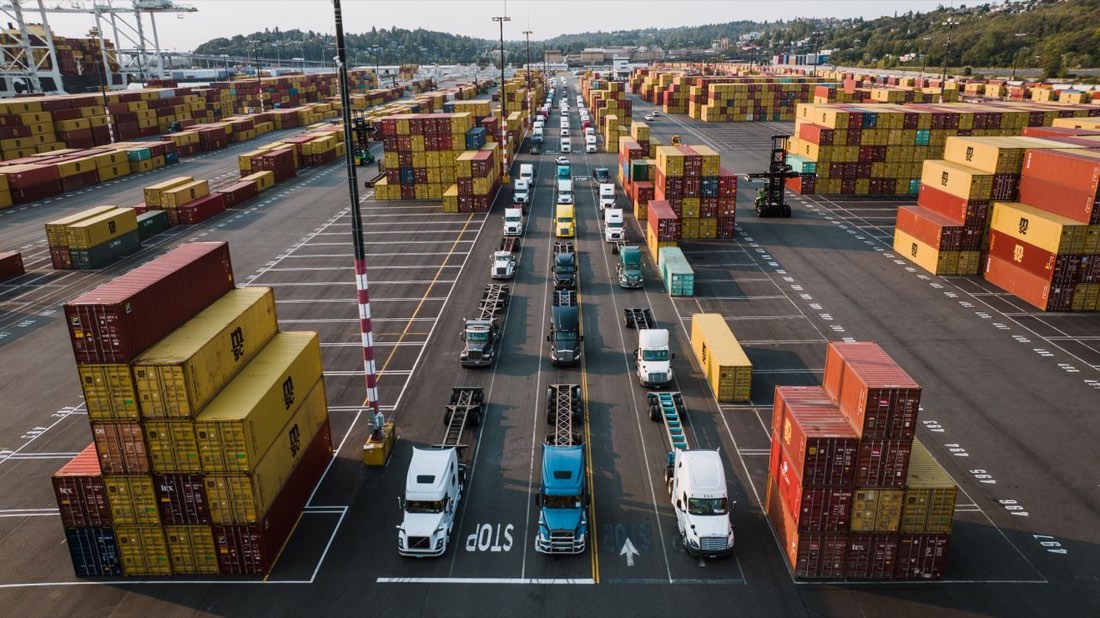 Drayage trucks lined up at a container terminal